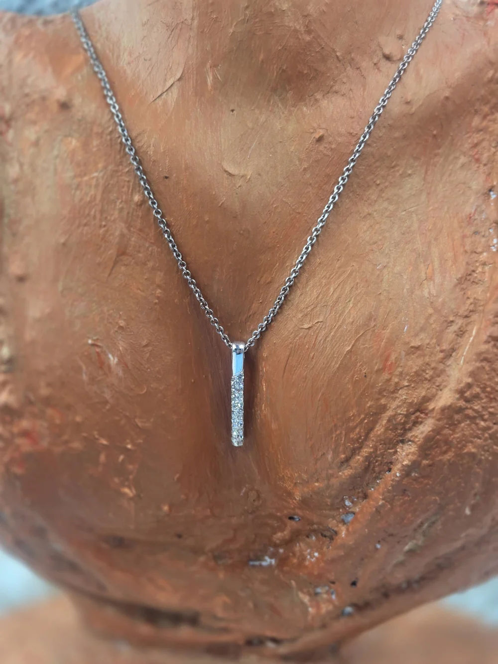 Nine West necklace features a dainty bar pendant adorned with pavé stones